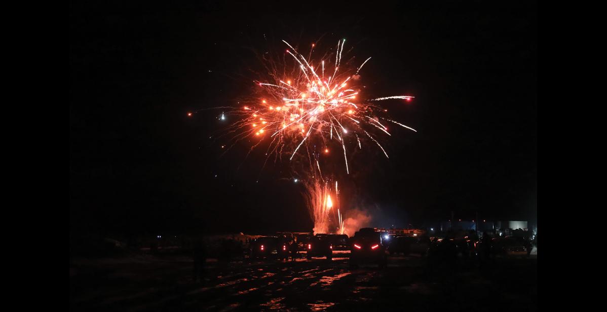 Photo by Laura Robertson HAPPY NEW YEAR— Nomeites watched the New Year’s Eve fireworks display in small groups spread across icy roads.