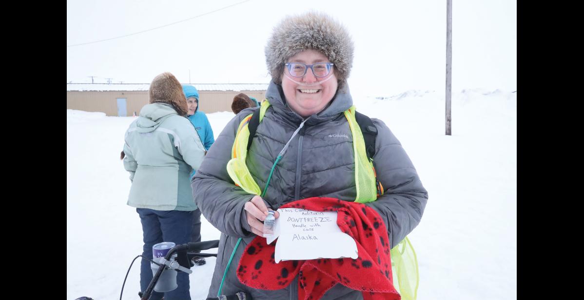 Photo by Laura Robertson NSHC's Megan Mackiernan accepted the "anti-toxin" from the mushers.