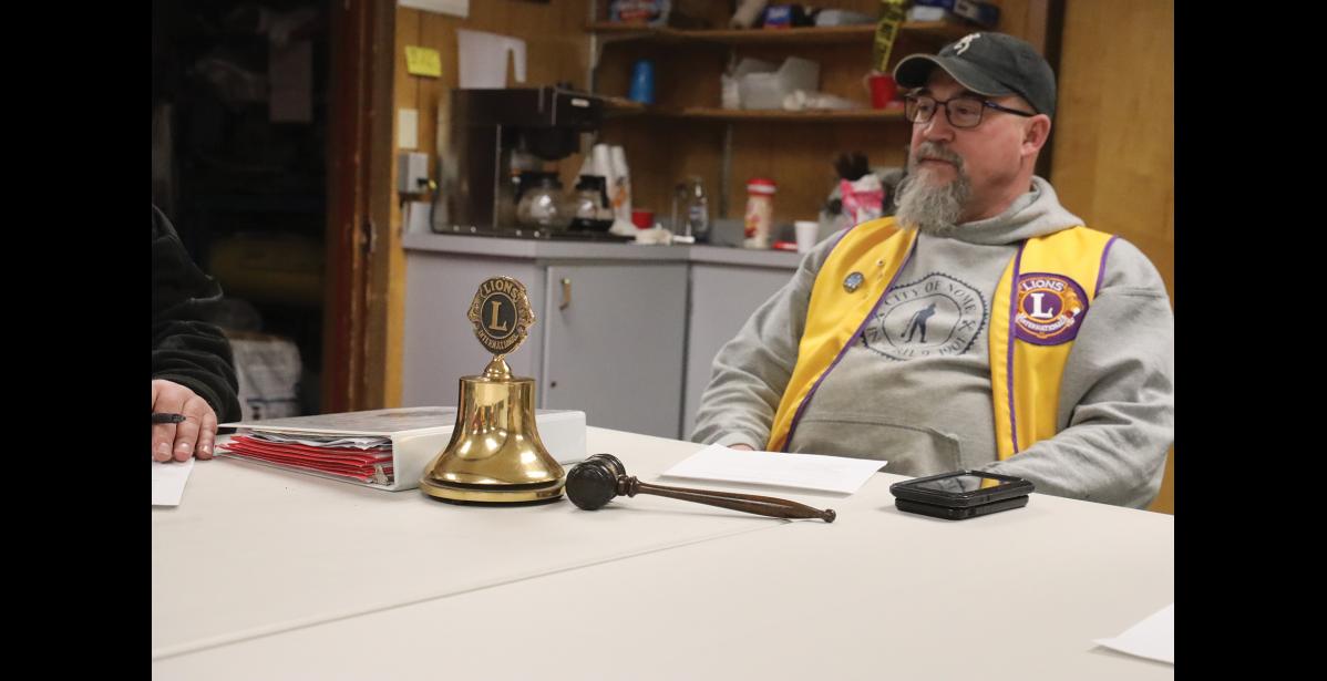 Photo by Laura Robertson CALL TO ORDER—Cole Cushman sits in front of a Lions International branded bell.