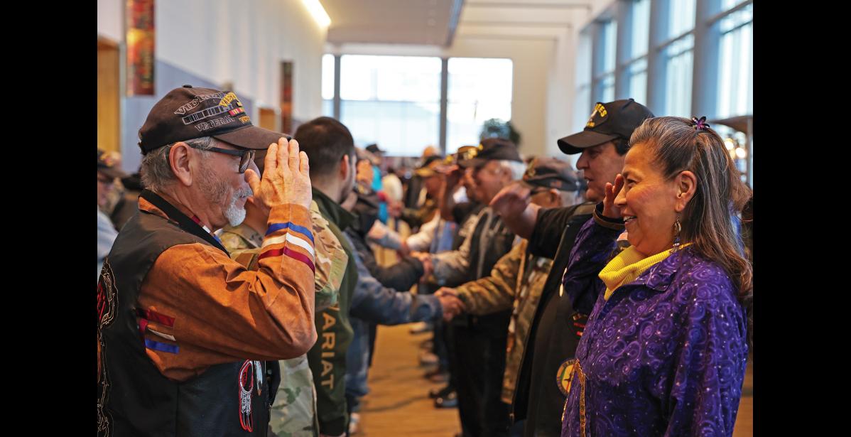 Photo by Megan Gannon VETERANS — Army Sergeant William Smith and Air National Guard Staff Sergeant Wanda Solomon-Parsons salute each other after the veterans’ walk at AFN on Thursday morning.