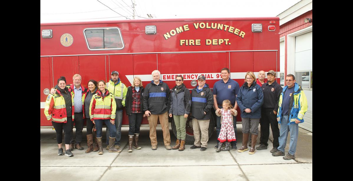 Photo by Peter Loewi Senator Lisa Murkowski, Representative Mary Peltola, and FEMA Administrator Deanne Criswell pose for a photo with some of Nome’s first responders.