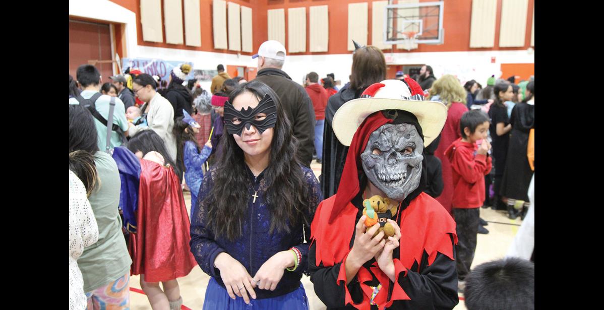 Photo by Peter Loewi Regina Cheemuk and Rodney Niksik pose in their costumes while waiting in line Friday night.