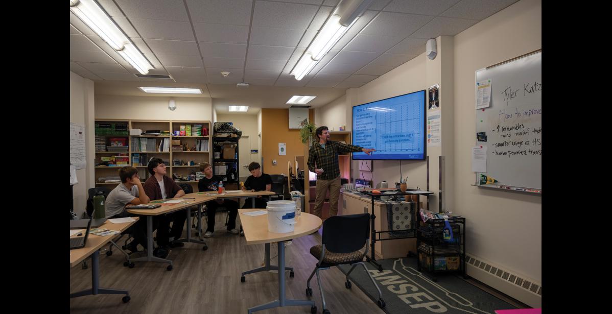 LEARNING— Lucas Pantelis, Levi Pederson, Max Breuker and Michael Koelsch listen to a presentation by Tyler Katzmar from the Renewable Energy Alaska Project at ANSEP Acceleration Academy on Friday, September 25. Photo by Ariana Crockett O'Harra