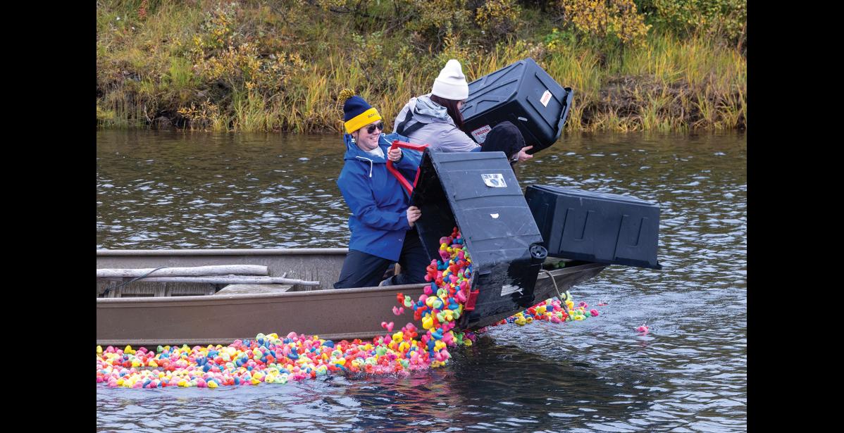 DUMPIN’ DUCKS (top) – Nicole Santonastaso, Sydney Boersma and Veronica Alviso dump rubber ducks into the Snake River for the Rotary Club of Nome’s Duck Race on Monday, September 7. Photo by Ariana Crockett O'Harra