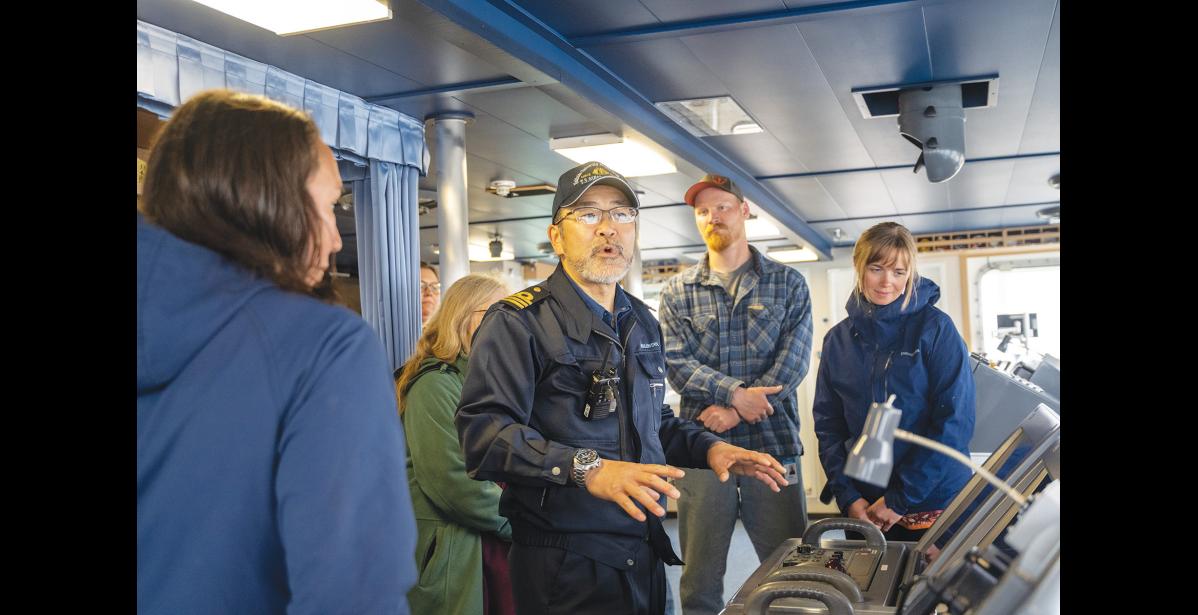 ON THE BRIDGE— First Officer of the Oshoro Maru Naoki Hoshi gives a tour of the bridge to visitors on July 10. Photo by Ariana Crockett O'Harra