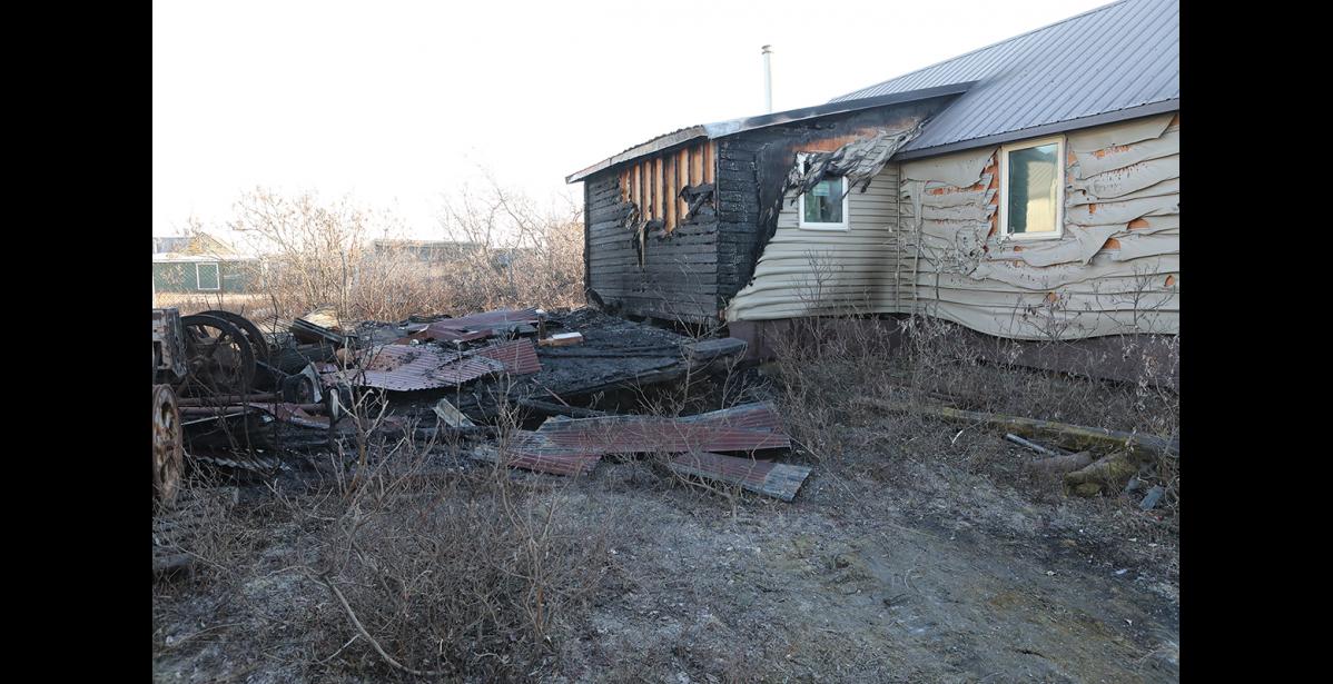 Photo by Diana Haecker BURNED— A suspicious fire consumed Randy Oles’ shed and partially burned the wall of his house on Steadman, on Tuesday night. The police are investigating a series of suspicious fires that occurred in the area over a span of a few weeks.