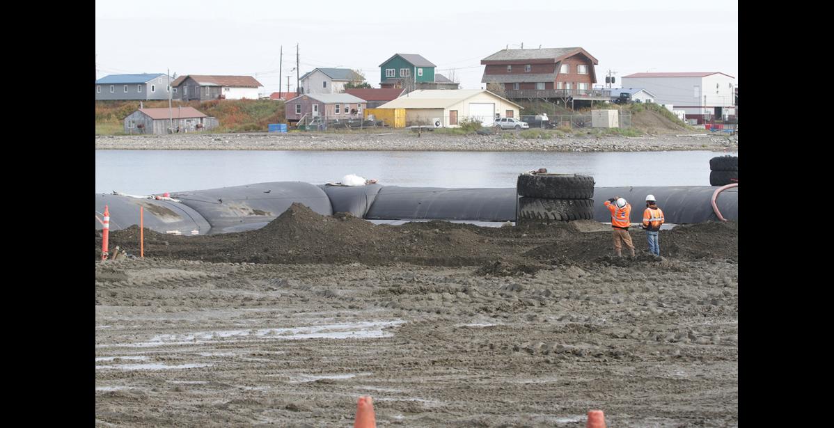 Photo by Diana Haecker BARGE RAMP REPAIR— Repairs of the launch ramp replacement hit a snag due to stormy weather, making it difficult to de-water the area to replace the concrete barge ramp. With the help of the pictured ‘aqua dam’ project contractors hope to achieve the de-watering to allow the installation of the concrete ramp