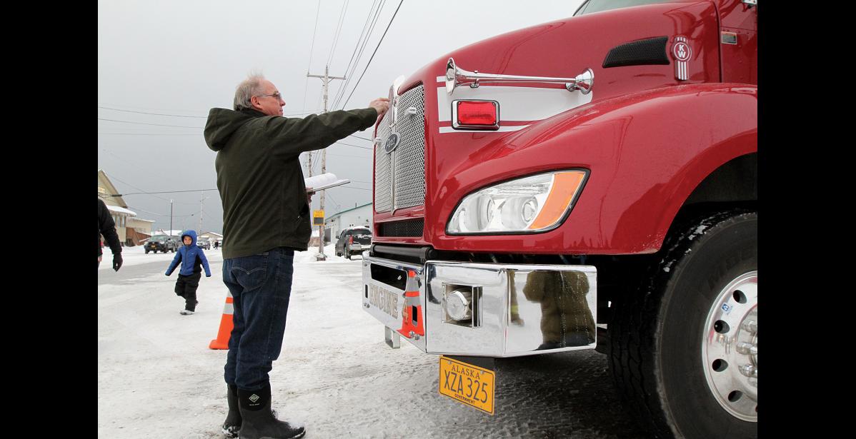 Photo by Diana Haecker Pastor Harvey Fiskeaux performed the ceremony, blessing the truck with words, water and oil.