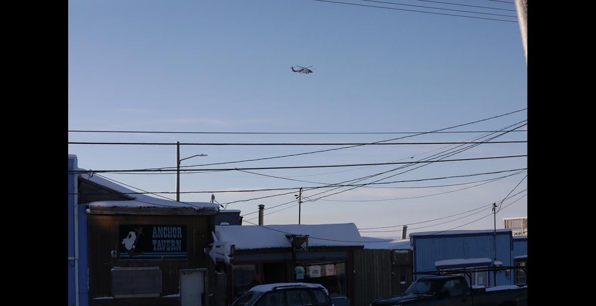 Photo by Diana Haecker A Coast Guard helicopter flies over Nome, on Friday, shortly after 1 p.m.