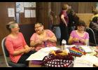 MK Romberg, Caroline Muktoyuk-Brown and Loretta Bullard share a laugh at the crocheting table at the Fiber Fest.