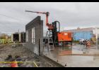 Photo by Laura Robertson FIRST WALL—The 3D printer prints the first wall of the experimental house in Nome on August 20, 2025.