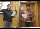 City Clerk Dan Grimmer administers the oath of office to student representative Lane Schuerch, during the Sept. 28 council meeting. Photo by Diana Haecker